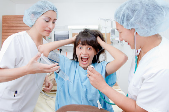 nurses and scared patient at hospital