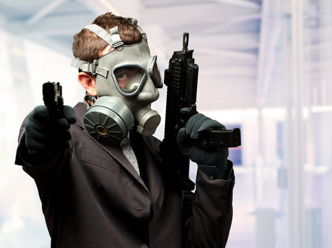 Businessman Holding Gun With Gas Mask
