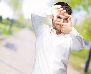 Portrait Of Young Man Making Hand Frame