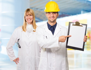 Portrait Of Technician Showing On Clipboard