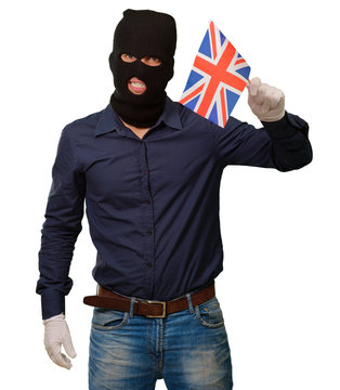 Portrait of a man wearing mask holding a flag