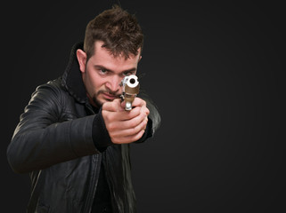 young man pointing with gun