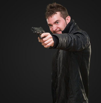 angry man pointing with gun