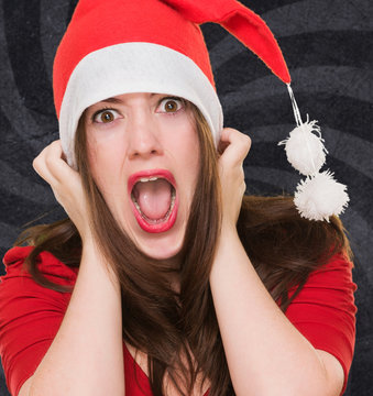 furious woman wearing a christmas hat