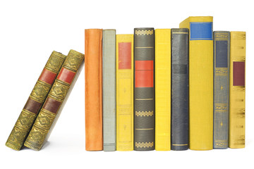 vintage books in a row, isolated on white background, blank labe