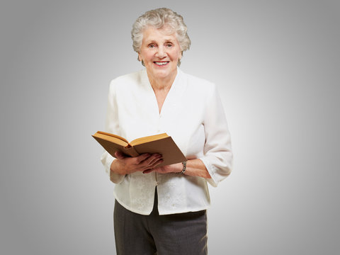 Portrait of a senior woman reading book