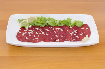 Bresaola with rocket cheese, green salad  and lemon