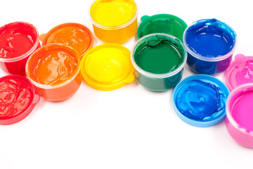 motley paints on the white background. paints arranged as rainbo