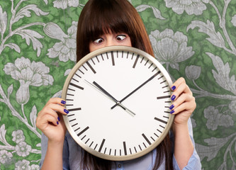 Woman Holding Clock With Squinted Eyes
