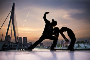 People dancing with Rotterdam on the background