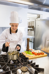 Smiling woman making soup