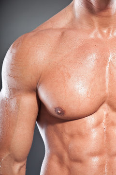 Closeup of shirtless muscled fitness man. Tough guy. Tanned skin
