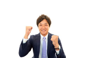 ガッツポーズをする笑顔のビジネスマン