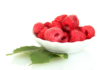 Fresh raspberries in white saucer isolated on white