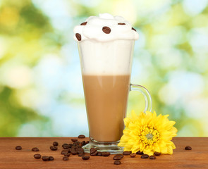 glass of fresh coffee cocktail on green background
