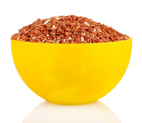 red  rice in a  yellow plate , isolated on white