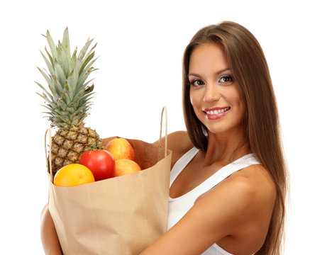 beautiful young woman with fruits in shopping paper bag,
