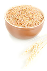 Brown bowl full of wheat bran isolated on white
