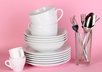 Clean white dishes on pink background