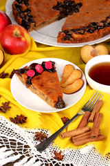 Tasty pie on plate on wooden table