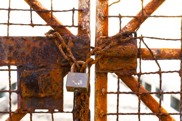 Metal door with rusty chain and key locked