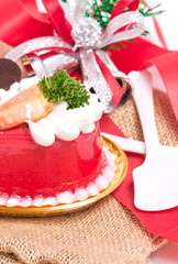 Fototapeta na wymiar Strawberry cake with bells and ribbon on burlap.