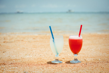 Pair of fruit shakes on the tropical beach 