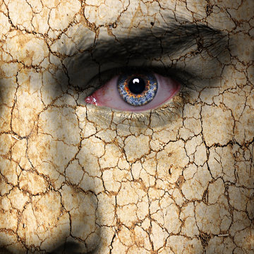 Cracked earth pattern on man face