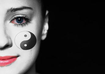 Woman face with jin yang symbol