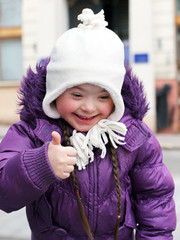 Portrait of beautiful happy girl giving thumbs up.