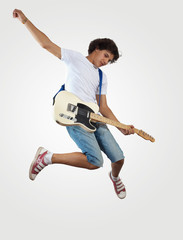 young man playing on electro guitar and jumping