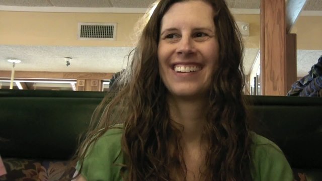 Woman Smiling & Laughing in Restaurant