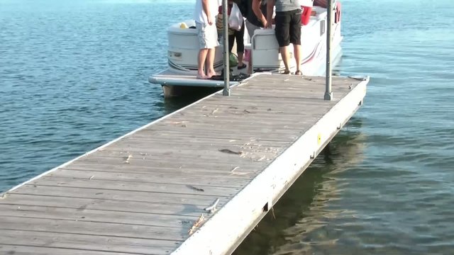 Boat Picking Up People on Dock