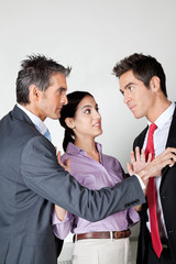 Businesswoman Acting As Peacemaker Between Colleagues