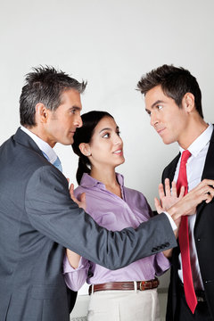 Businesswoman Acting As Peacemaker Between Colleagues