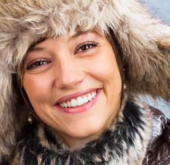 Happy laughing beautiful woman with fur hat