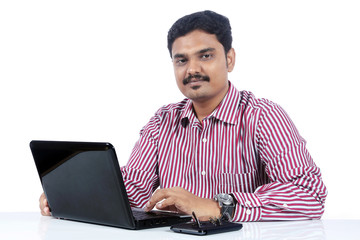 Young Indian business man using laptop