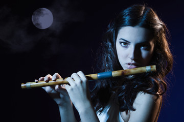 Sensuality brunette plays a wooden flute