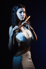 Fototapeta premium Sensuality brunette with a wooden flute