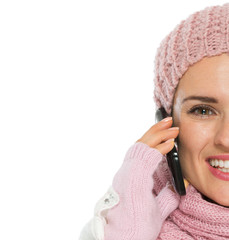 Closeup on happy woman in knit winter clothing speaking mobile