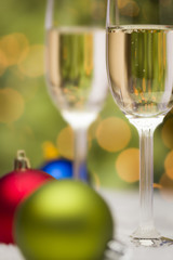 Christmas Ornaments and Champagne Glasses on Snow