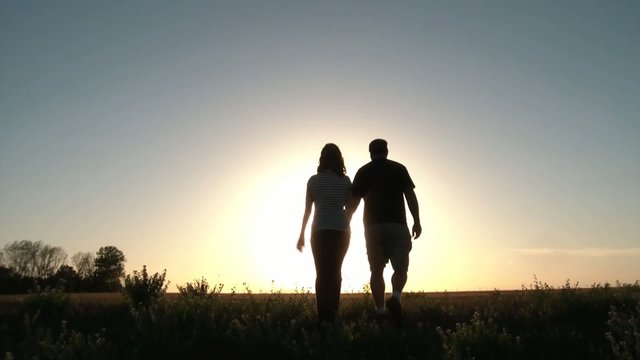 Romantic Couple Walks Into Sunset