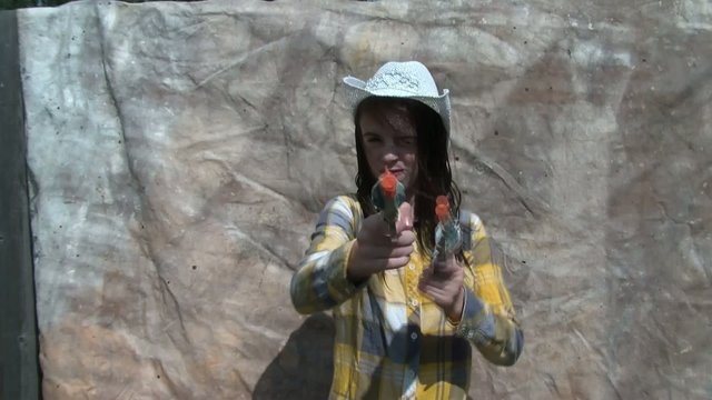 Cowgirl Shooting Guns with Fake Teeth