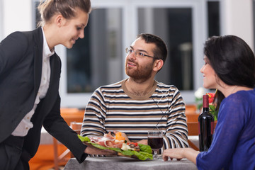 Young Couple at Restaurant with Waitress