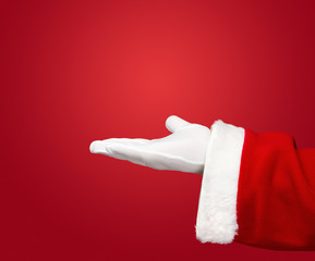 Santa Claus hand presenting your christmas text or product