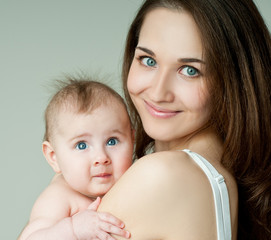Young mother hugging baby