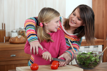 Fototapeta premium Mother cooking with daughter