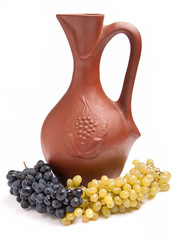 traditional clay jug for wine with bunch grapes