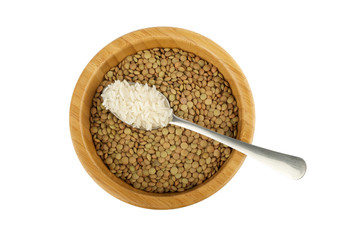 wood bowl with lentil and steel spoon with rice