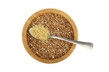 wood bowl with buckwheat and steel spoon with vermicelli